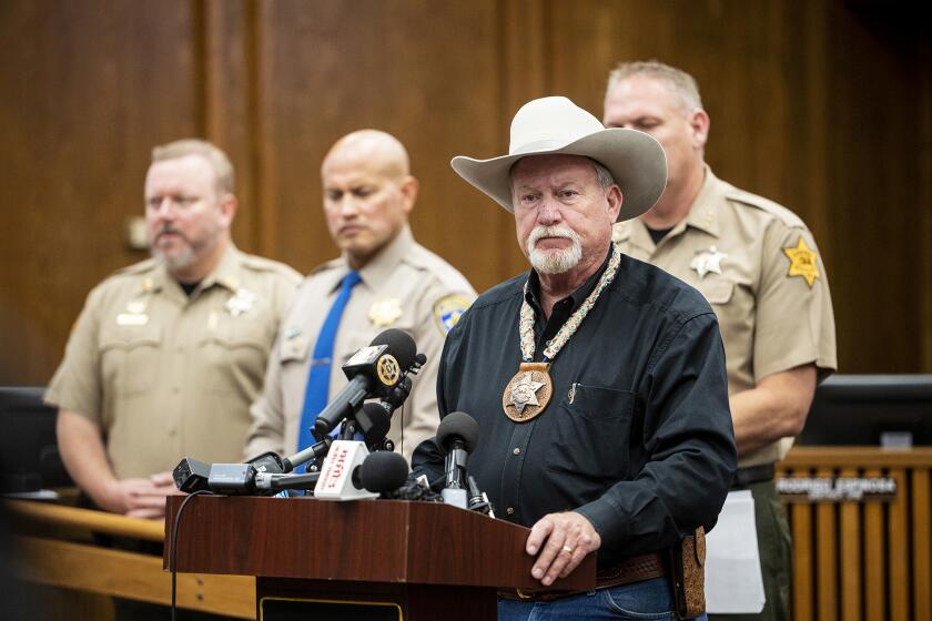 Merced County Sheriff Vern Warnke, foreground, speaks at a news conference about the kidnapping of 8-month-old Aroohi Dheri, her mother Jasleen Kaur, her father Jasdeep Singh, and her uncle Amandeep Singh, in Merced, Calif., on Wednesday, Oct. 5, 2022. Relatives of a family kidnapped at gunpoint from their trucking business in central California pleaded for help Wednesday in the search for an 8-month-old girl, her mother, father and uncle, who authorities say were taken by a convicted robber who tried to kill himself a day after the kidnappings. (Andrew Kuhn/The Merced Sun-Star via AP)