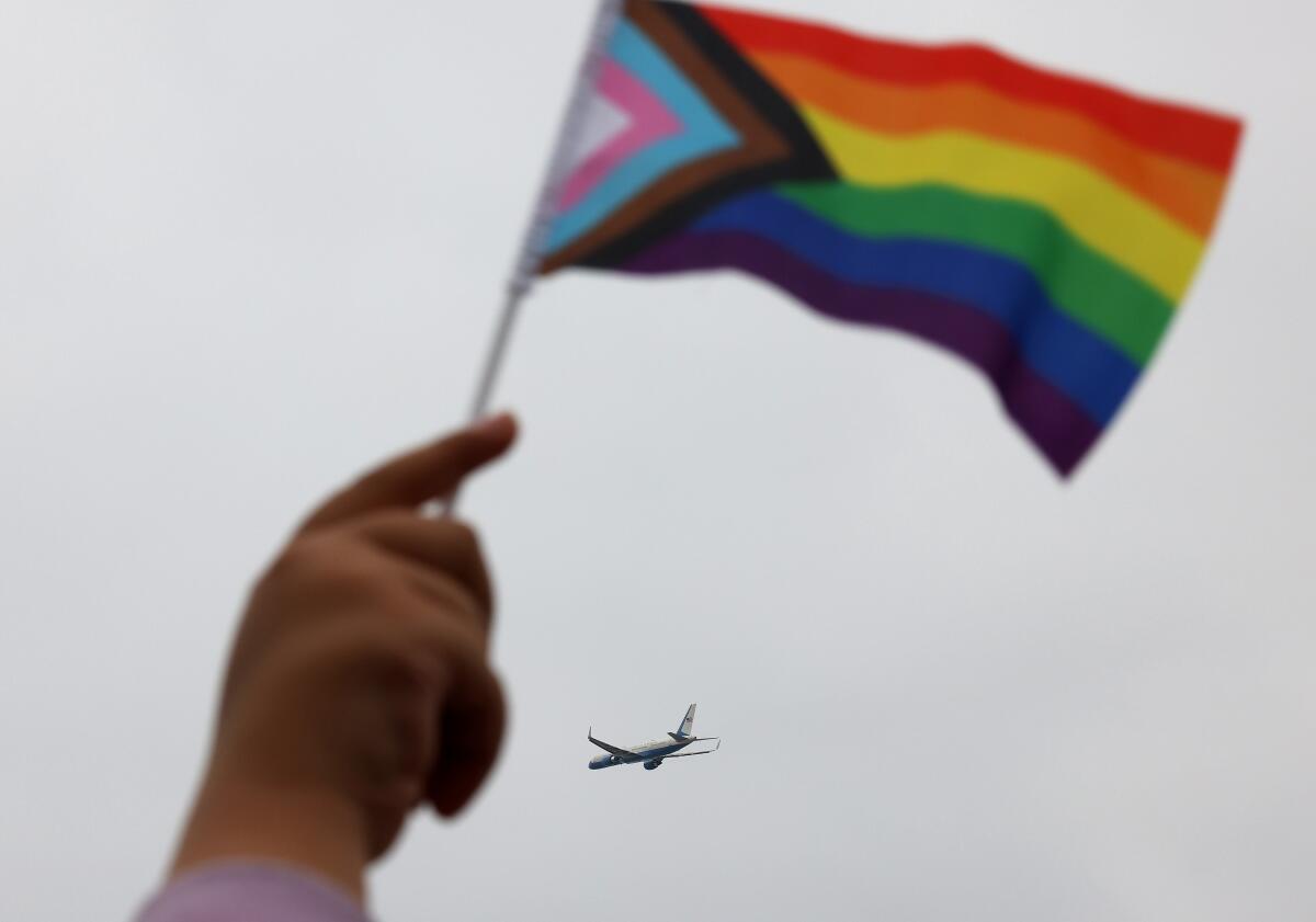 A person waves a pride flag 