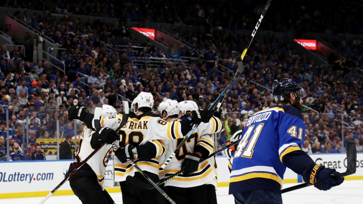 Boston Bruins' Torey Krug (47) is congratulated by his teammates after scoring a second period goal against the St. Louis Blues in Game 3 of the Stanley Cup Final on Saturday.