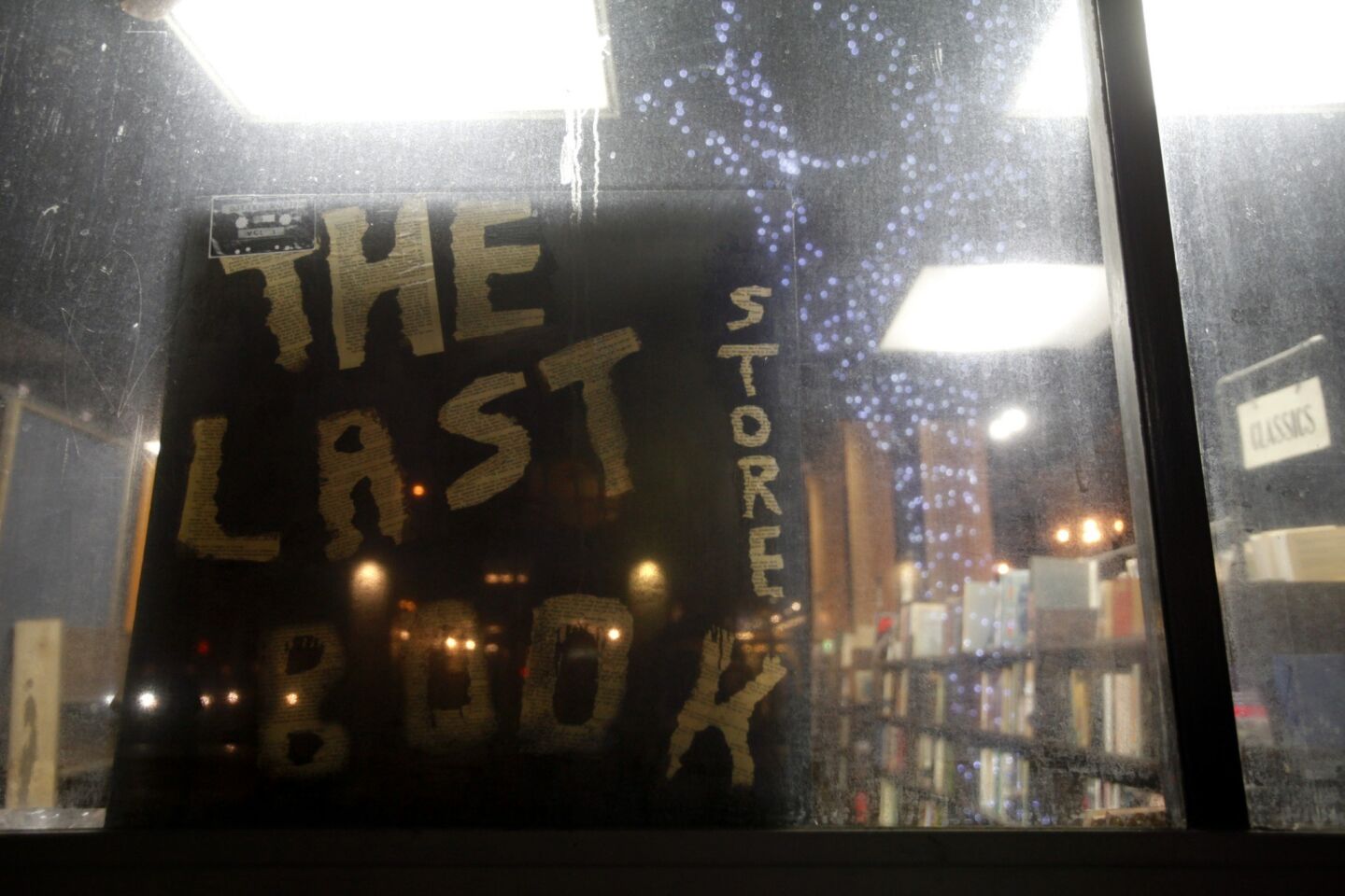 A sign for the Last Bookstore rests in the front window.