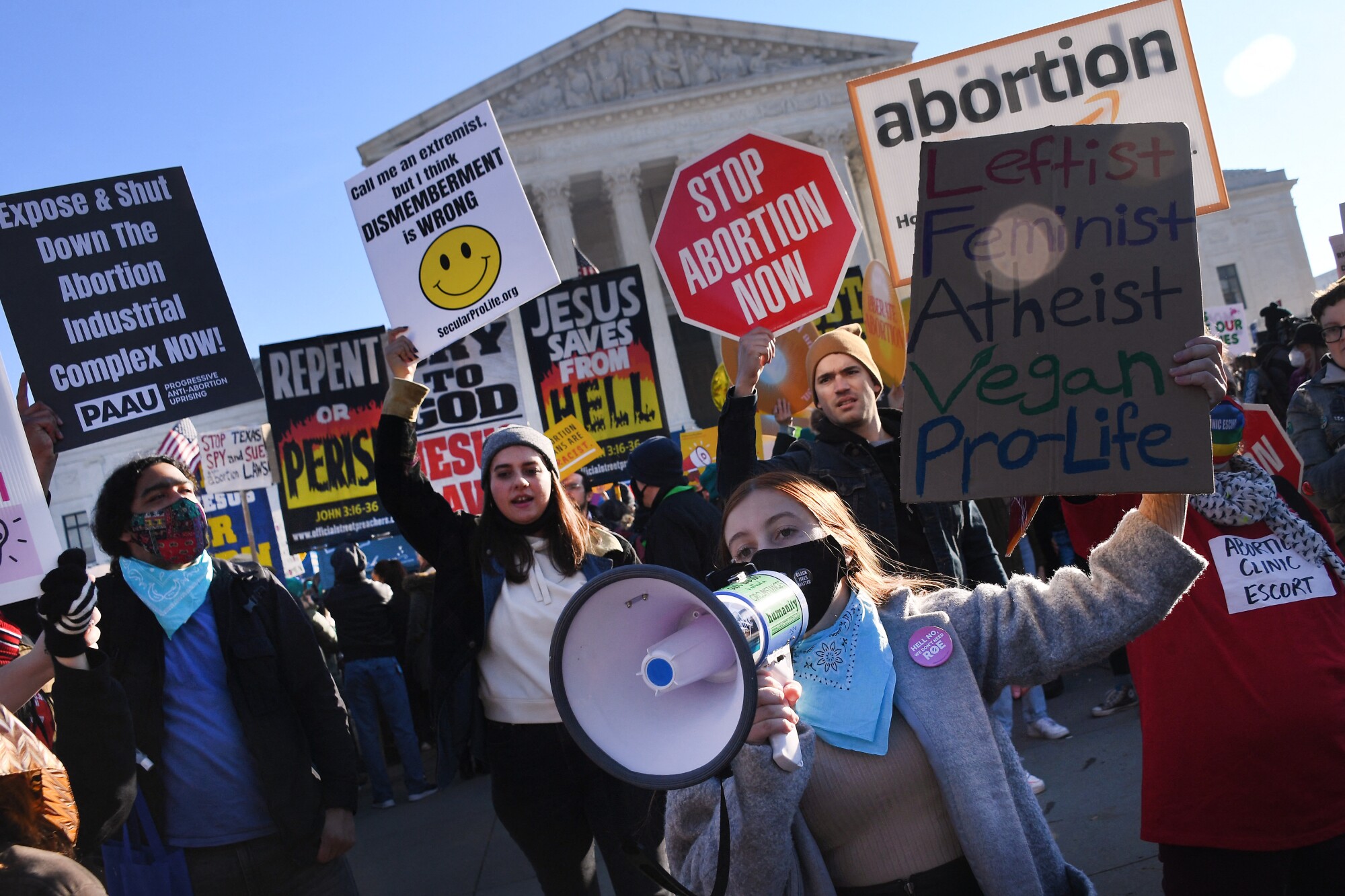 Abortion rights advocates and anti-abortion protesters demonstrate with signs