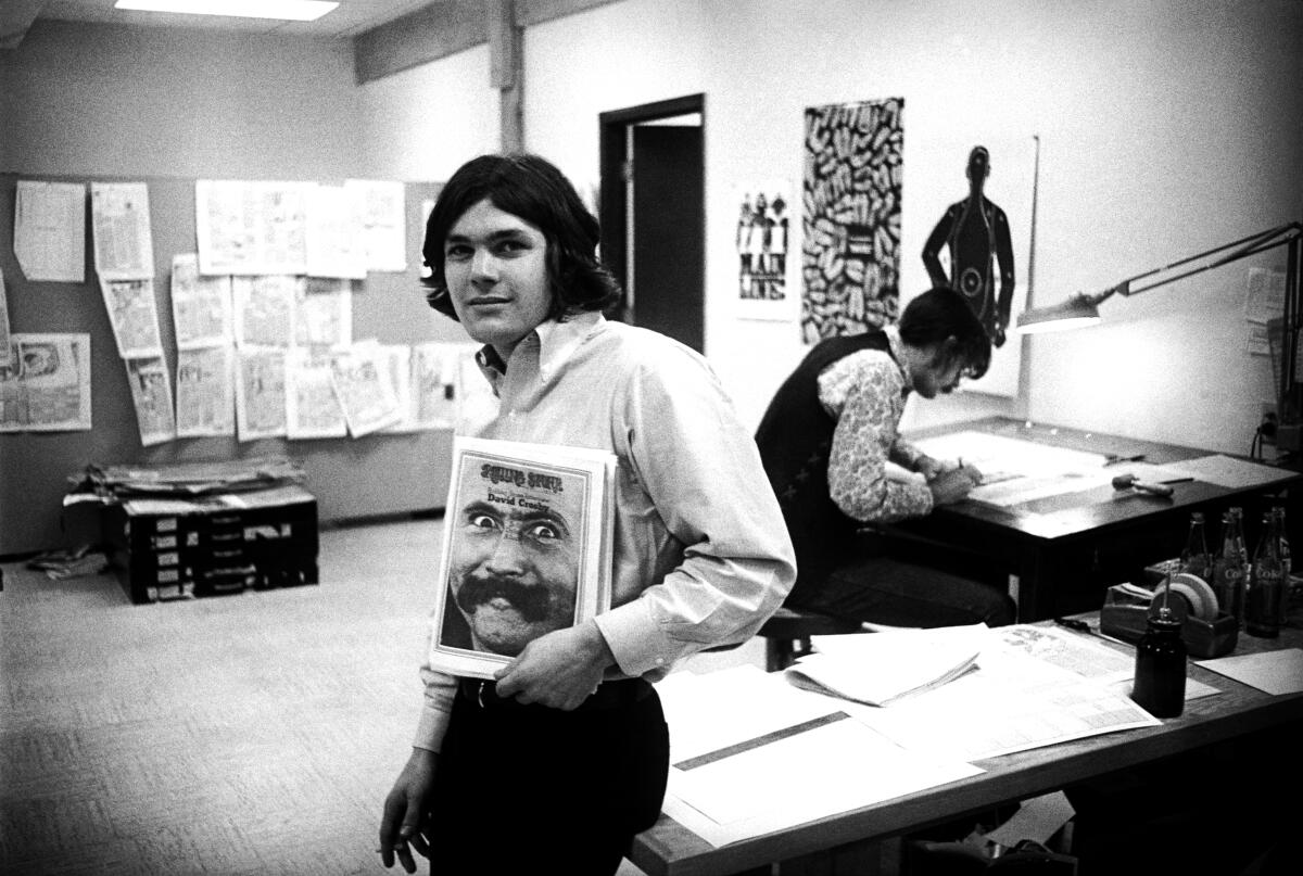 Rolling Stone co-founder Jann Wenner holding a magazine in 1970.