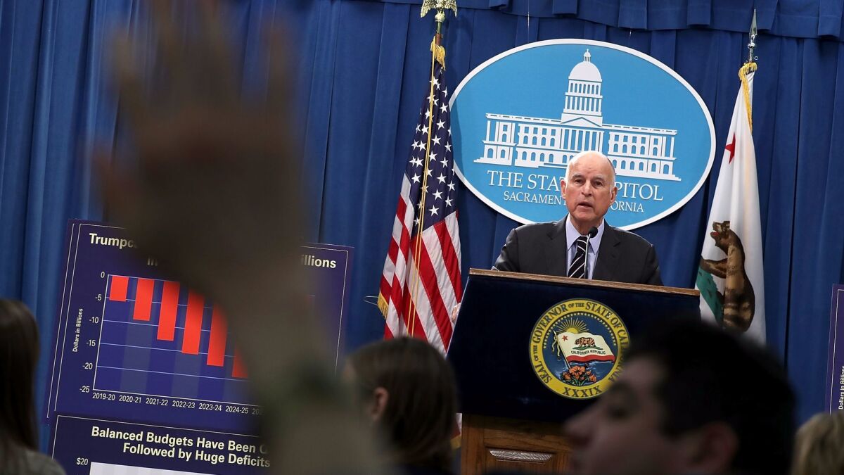 Gov. Jerry Brown speaks to reporters during a Thursday news conference where he revealed his revised state budget.