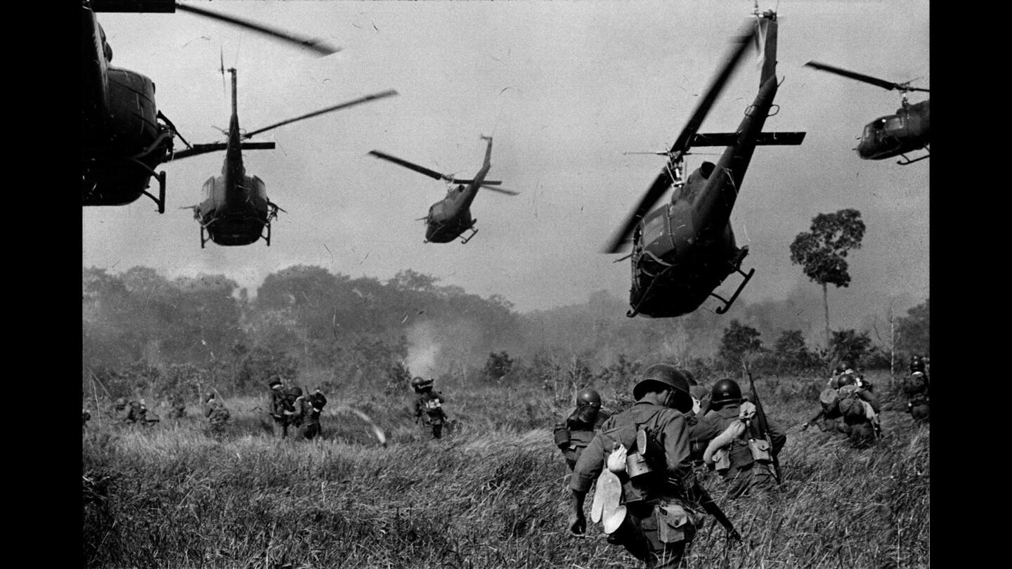 In this March 1965 image, U.S. Army helicopters fire into the tree line to cover the advance of South Vietnamese ground troops in an attack on a Viet Cong camp 18 miles north of Tay Ninh, Vietnam, near the Cambodian border.