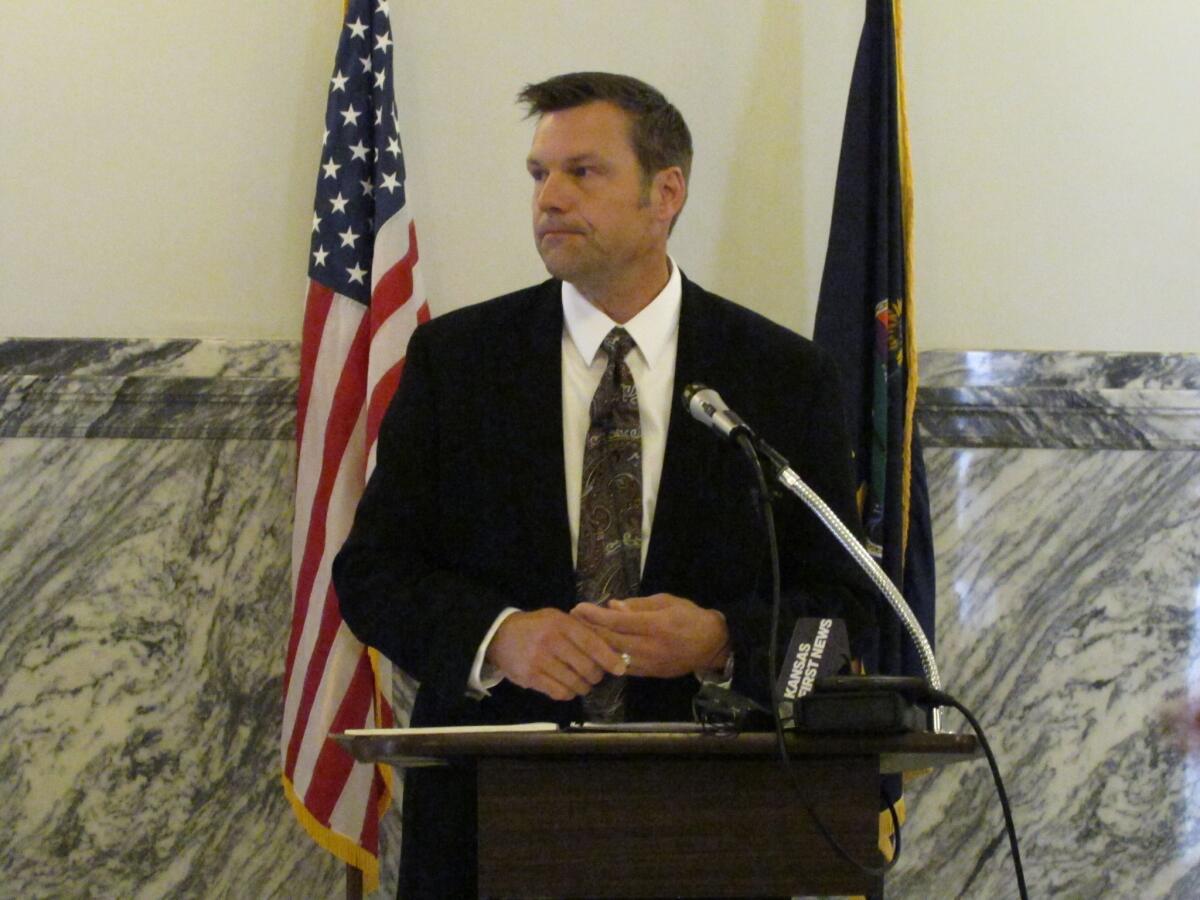 Kansas Secretary of State Kris Kobach speaks to reporters after a state Supreme Court ruling requiring him to remove the Democratic nominee for the U.S. Senate from the ballot Thursday. Democrat Chad Taylor wanted to withdraw, but Kobach blocked the move.