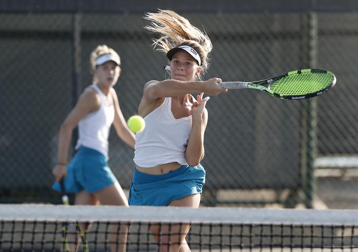 Reece Kenerson scores at the net as Corona del Mar doubles partner Jane Paulsen looks on against Huntington Beach in the semifinals of the CIF Southern Section Division 1 playoffs on Wednesday in Newport Beach.