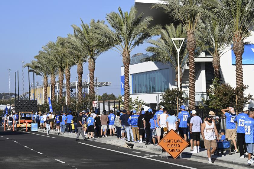 Chargers fans line up outside "The Bolt" facility to watch the team's training camp workout Saturday in El Segundo.