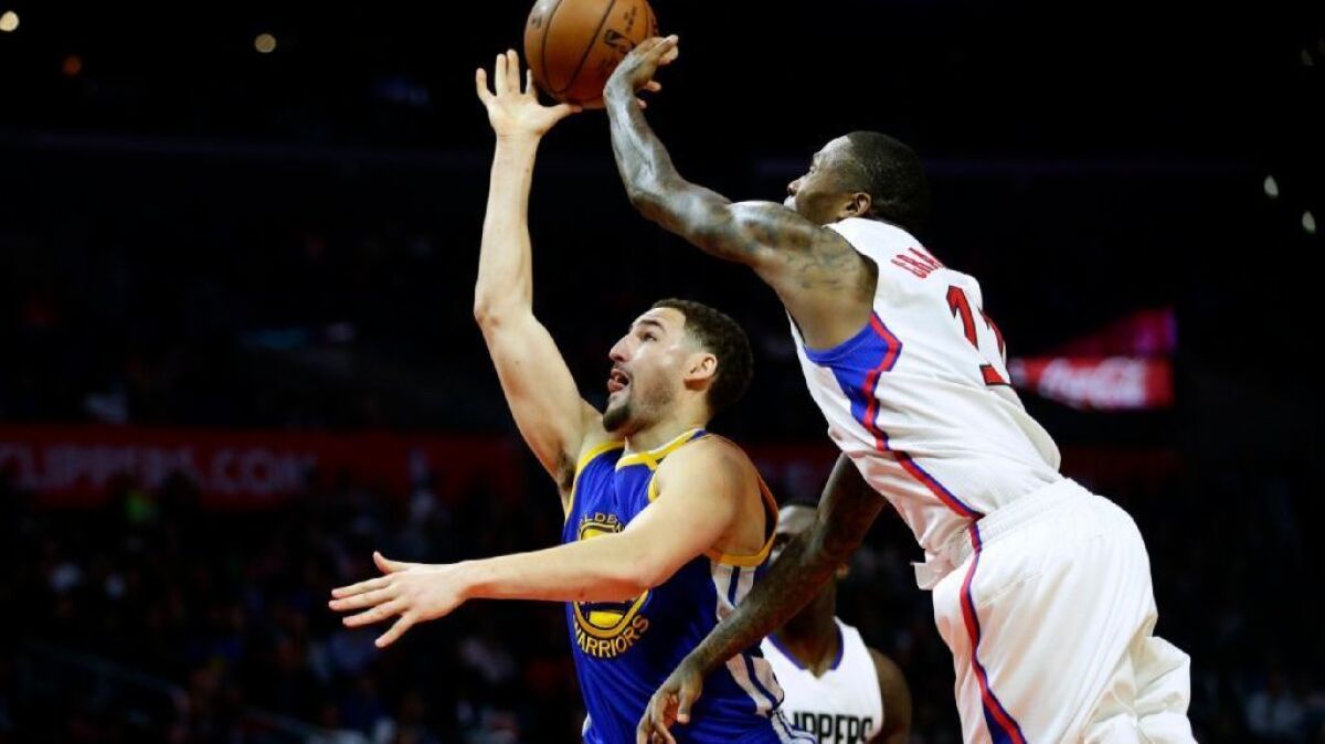 Clippers guard Jamal Crawford blocks the shot of Warriors forward Klay Thompson during the second half of Thursday's game at Staples Center.