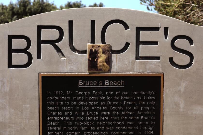 MANHATTAN BEACH, CA - APRIL 9 - - A marker gives the history of Bruce's Beach in Manhattan Beach on April 9, 2021. Los Angeles Supervisor Janice Hahn announced that the process of returning Bruce's Beach back to the family of Willa and Charles Bruce has begun. Sen. Steven Bradford has created SB 796 that will allow Bruce's Beach to be returned to surviving members of the Bruce family. In 1912, a young Black couple named Willa and Charles Bruce purchased beachfront property in Manhattan Beach and built a beautiful beach resort that served Black residents. It was one of the few beaches where Black residents could go because so many other local beaches did not permit Black beachgoers. The Bruce's and their customers were harassed and threatened by white neighbors including the KKK. Eventually, the Manhattan Beach City Council moved to seize the property using eminent domain, purportedly to create a park. The Council took the property in 1929 and it remained empty for many years. The property the Bruce's once owned was years later transferred to the State and in 1995 transferred to Los Angeles County. It is now the site of the Los Angeles County Lifeguard Training Headquarters. APRIL 09: Manhattan Beach Friday, April 9, 2021 Manhattan Beach, CA. (Genaro Molina / Los Angeles Times)