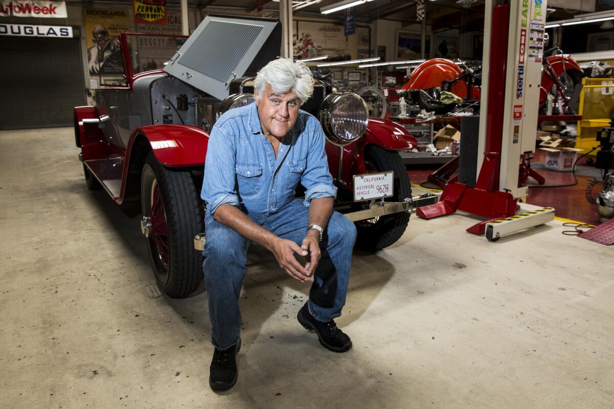 Comedian and car aficionado Jay Leno next to a 1925 Doble Steam car, once owned by Howard Hughes, inside his Big Dog Garage in Burbank on Oct. 2, 2015.