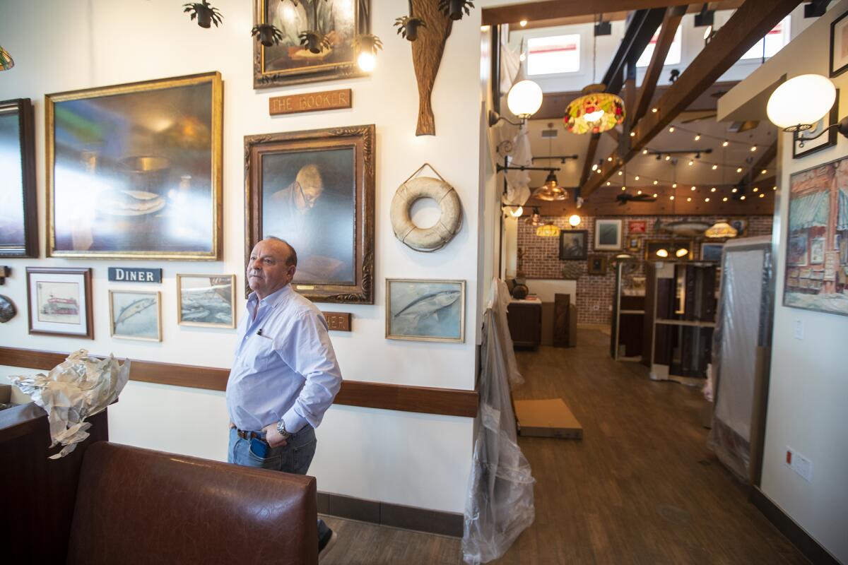 Jim Wasko, the owner of the new Crab Cooker in Newport Beach, looks around at the interior.