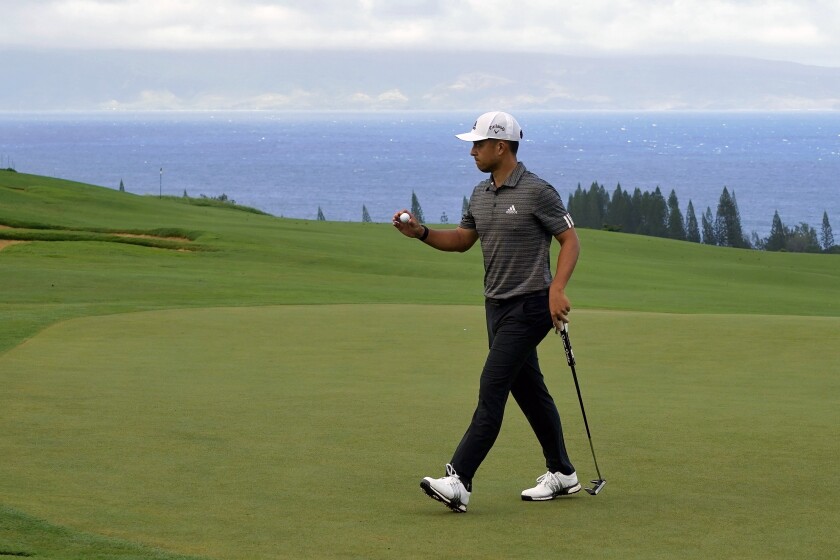 FILE - Xander Schauffele acknowledges the gallery after putting on the fourth green during the third round of the Tournament of Champions golf event at Kapalua Plantation Course in Kapalua, Hawaii, in this Saturday, Jan. 4, 2020, file photo. Schauffele is among 16 players in the Tournament of Champions who didn't win last year. (AP Photo/Matt York, File)