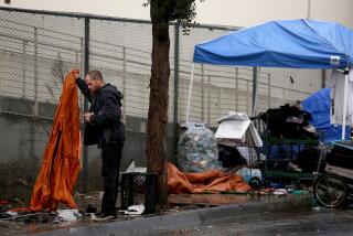 VENICE, CA - JANUARY 4, 2023 - - A homeless man salvages items left from an abandoned encampment on Hampton Ave. in Venice on January 4, 2023. Many of the homeless, who once lived in the encampments, were given housing at the LA Inn and Suites as part of the Inside Safe initiative. Over a dozen other homeless were taken from the area and given housing at the same hotel. Mayor Karen Bass and Councilwoman Traci Park announced that the Mayor's new Inside Safe initiative was underway in Venice. Outreach has begun to people living in encampments surrounding the A Bridge Home site at the intersection of Sunset Avenue and Pacific Avenue, and people who had accepted housing were taken by bus to a hotel in Los Angeles. Inside Safe is a new, citywide, proactive housing-led strategy to bring people inside from tents and encampments for good, and to prevent encampments from returning. (Genaro Molina / Los Angeles Times)