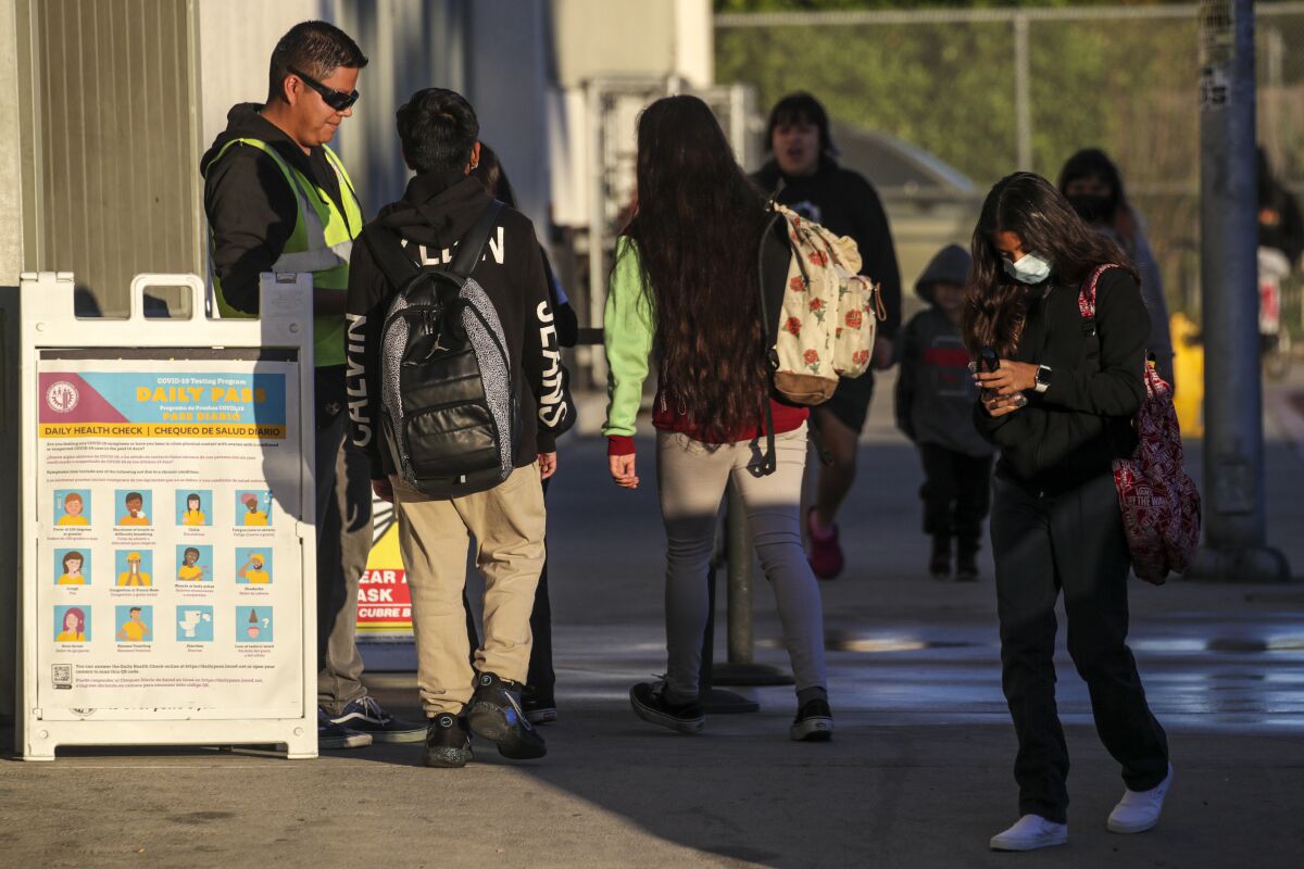 Students arrive at the Dr. Julian Nava Learning Academy in Los Angeles on March 23. 