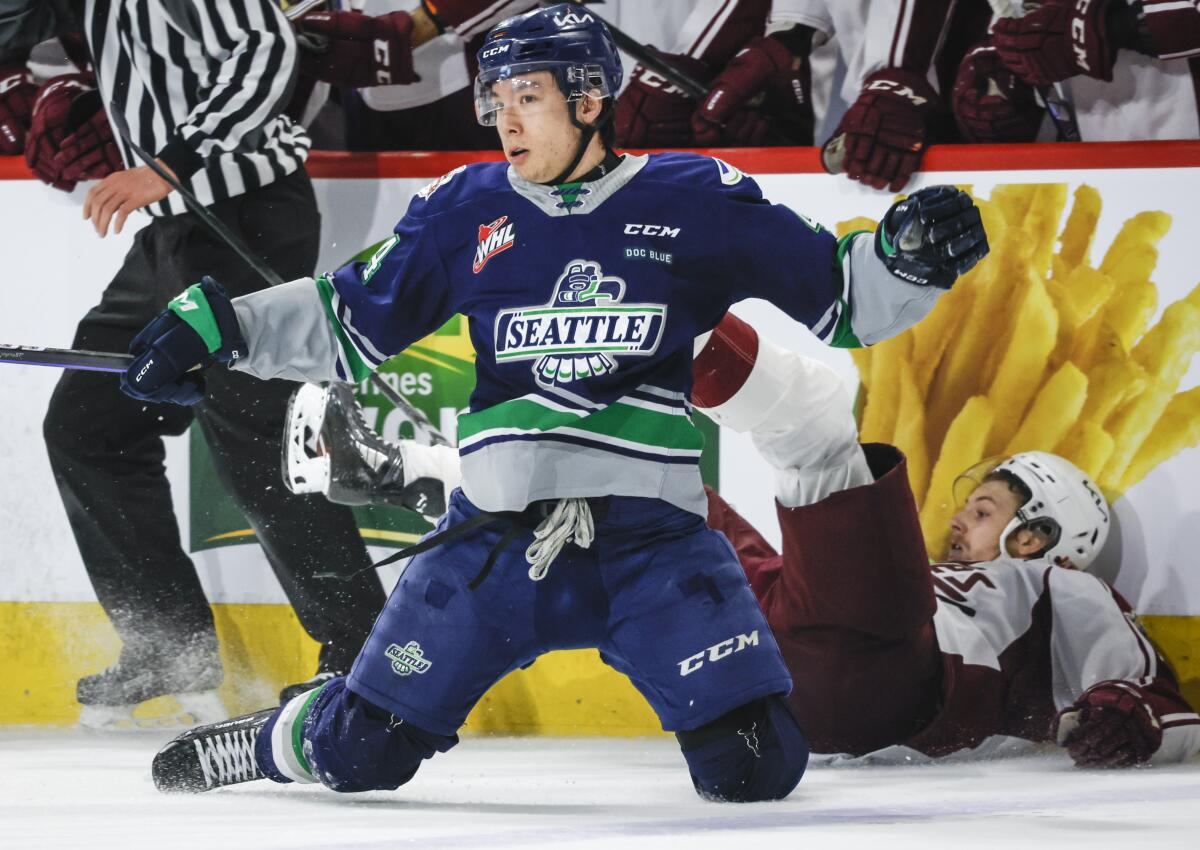 Seattle Thunderbirds defenseman Jeremy Hanzel, front, looks around after checking Peterborough Petes forward Brennan Othmann during the second period of a CHL Memorial Cup hockey semifinal Friday, June 2, 2023, in Kamloops, British Columbia. (Jeff McIntosh/The Canadian Press via AP)
