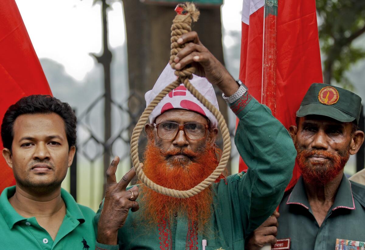 Bangladeshi activists who support capital punishment for war criminals rally outside the Supreme Court in Dhaka on Wednesday ahead of a verdict that upheld the death sentences of two opposition leaders.