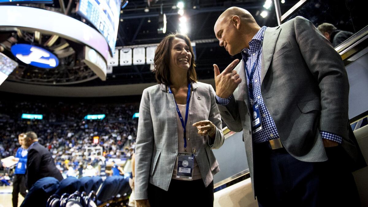 West Coast Conference Commissioner Gloria Nevarez talks with BYU Deputy Athletic Director Brian Santiago during a game between BYU and Gonzaga on Jan. 31.