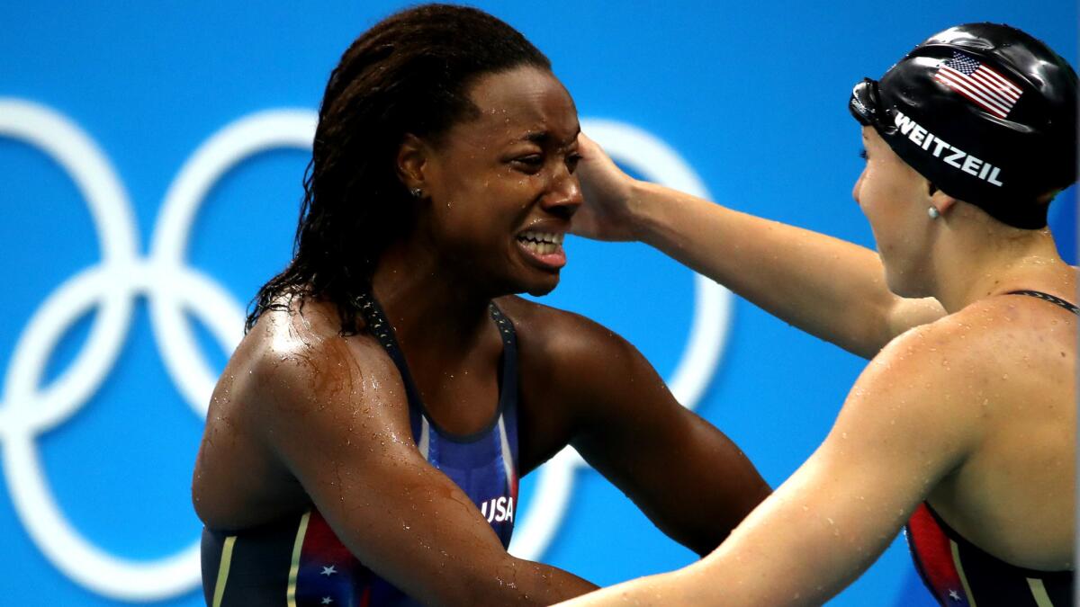American swimmer Simone Manuel is congratulated by teammate Abbey Weitzel after winning the gold medal in the 100-meter freestyle on Thursday.