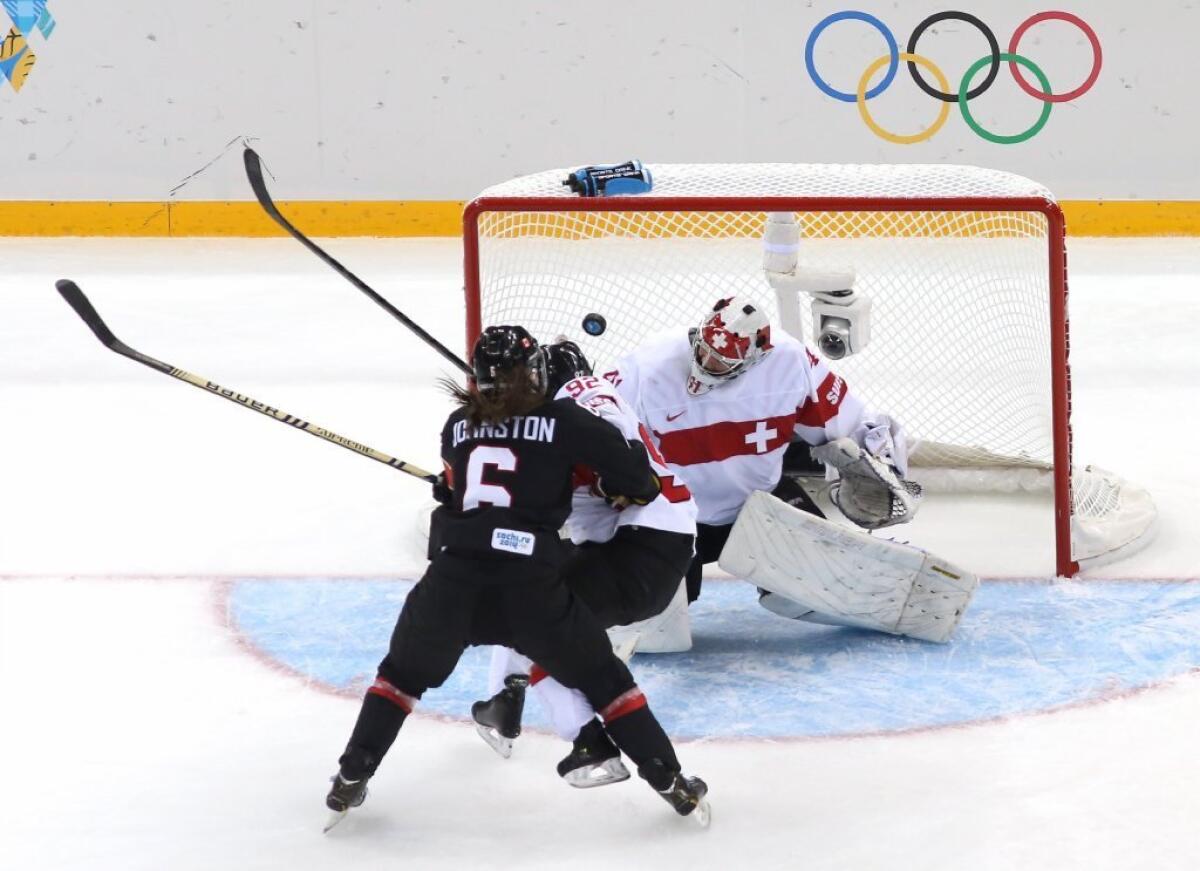 Rebecca Johnston of Canada scores a goal against Florence Schelling of Switzerland.