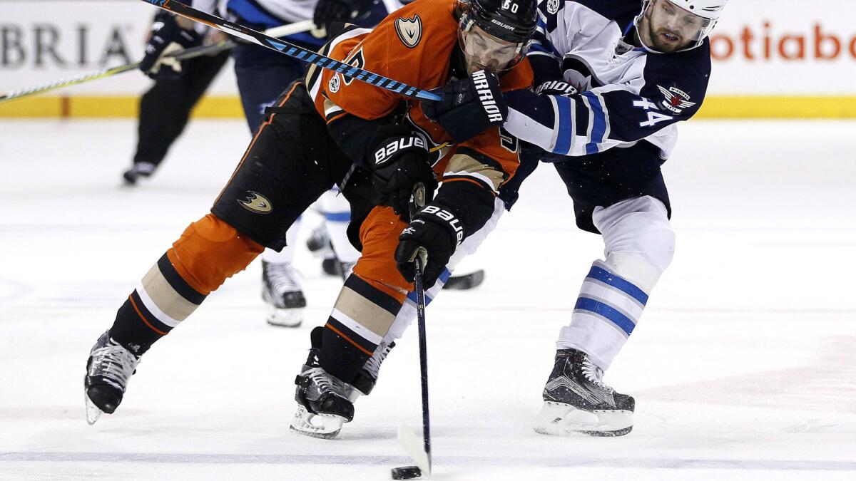 Ducks center Antoine Vermette steals the puck from Jets defenseman Josh Morrissey during the second period Thursday night.