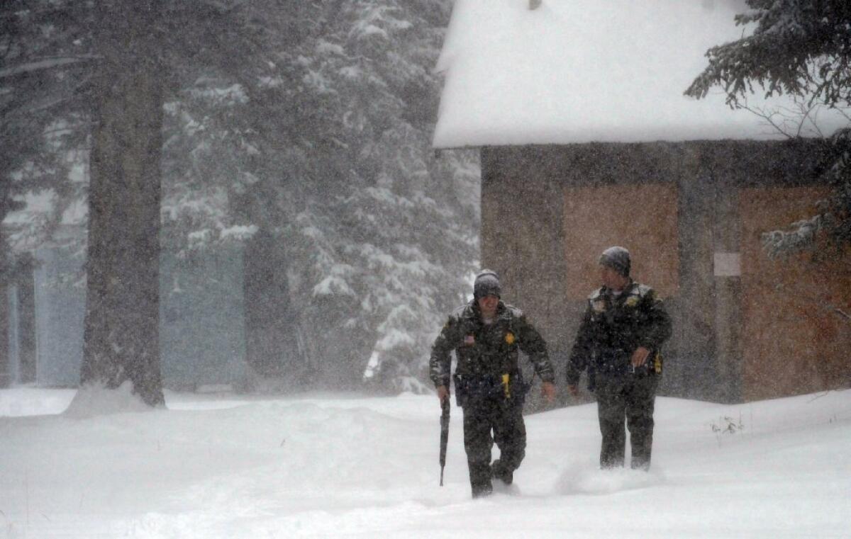 San Bernardino County sheriff's deputies battle the cold Friday during the hunt for murder suspect Christopher Dorner. In frigid conditions, life-threatening hypothermia can strike in less than an hour.