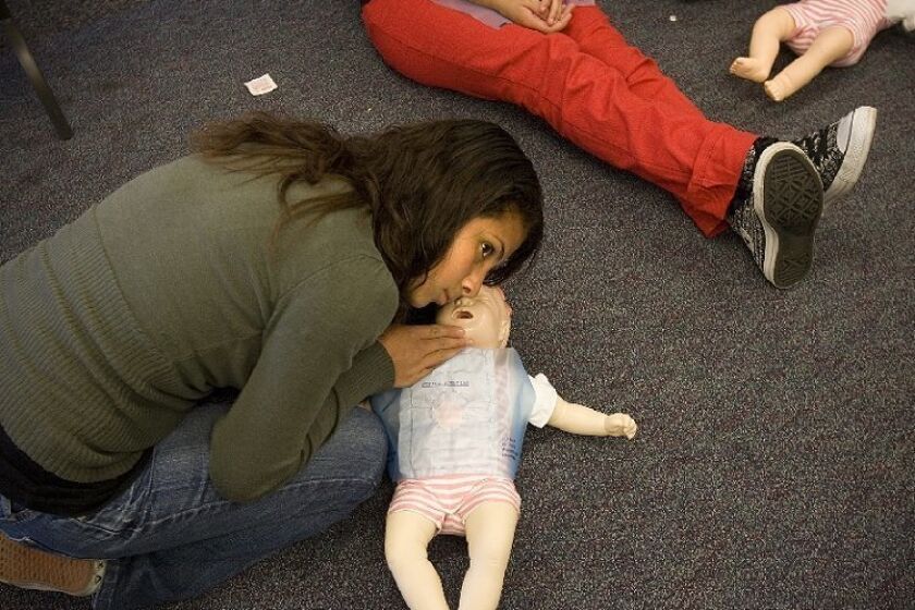 Angelina Aguilon checked the breathing of a baby doll Tuesday during a CPR class at Hoover High School. The exercise was part of Faces for the Future, a partnership between the school and Rady Children's Hospital.