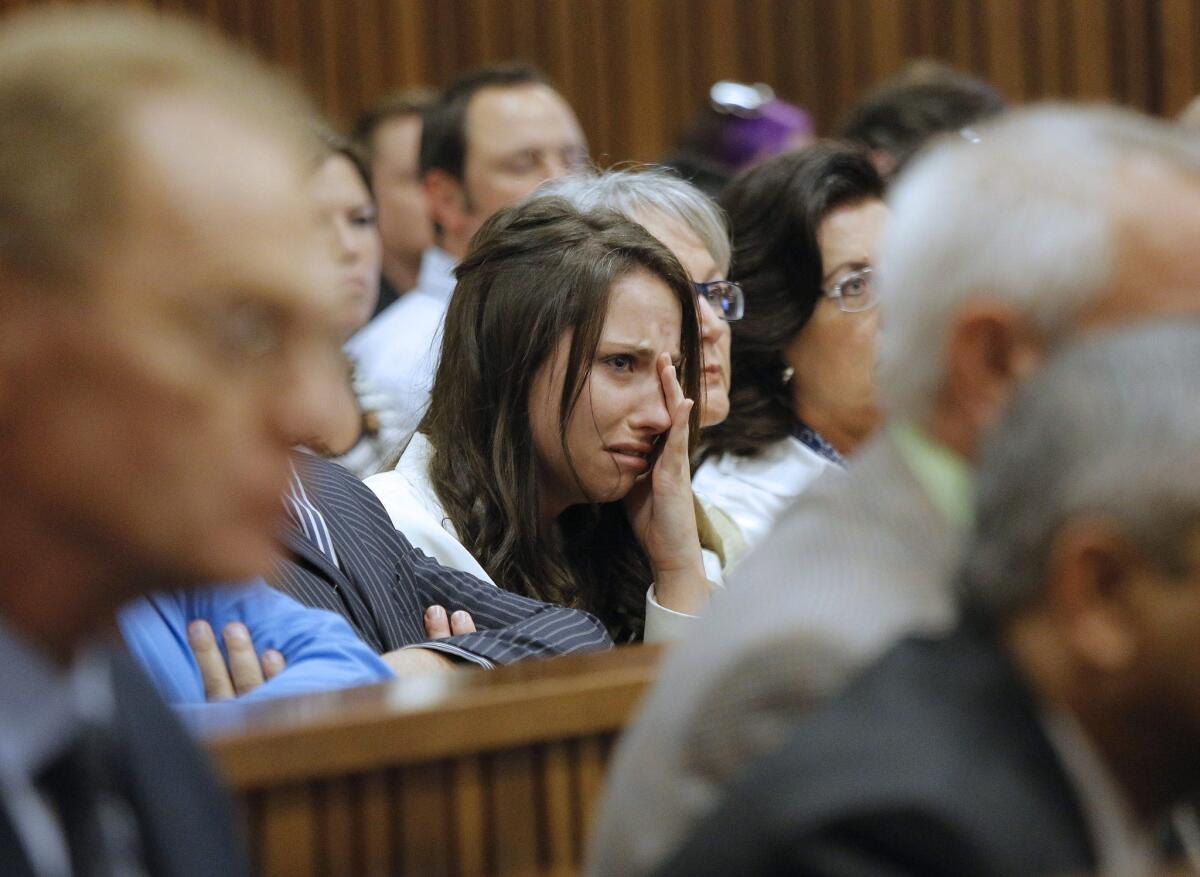 Aimee Pistorius cries as she hears her brother, Olympic sprinter Oscar Pistorius, recount his version of the events on the night he killed Reeva Steenkamp.