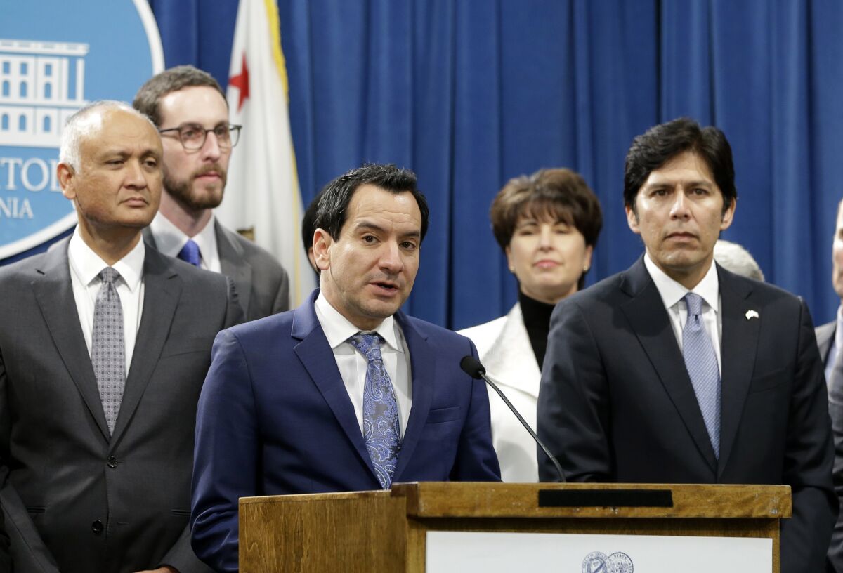 Assembly Speaker Anthony Rendon, center, and Senate President Pro Tem Kevin de León, right, preside over the fractious relationship between their two chambers.