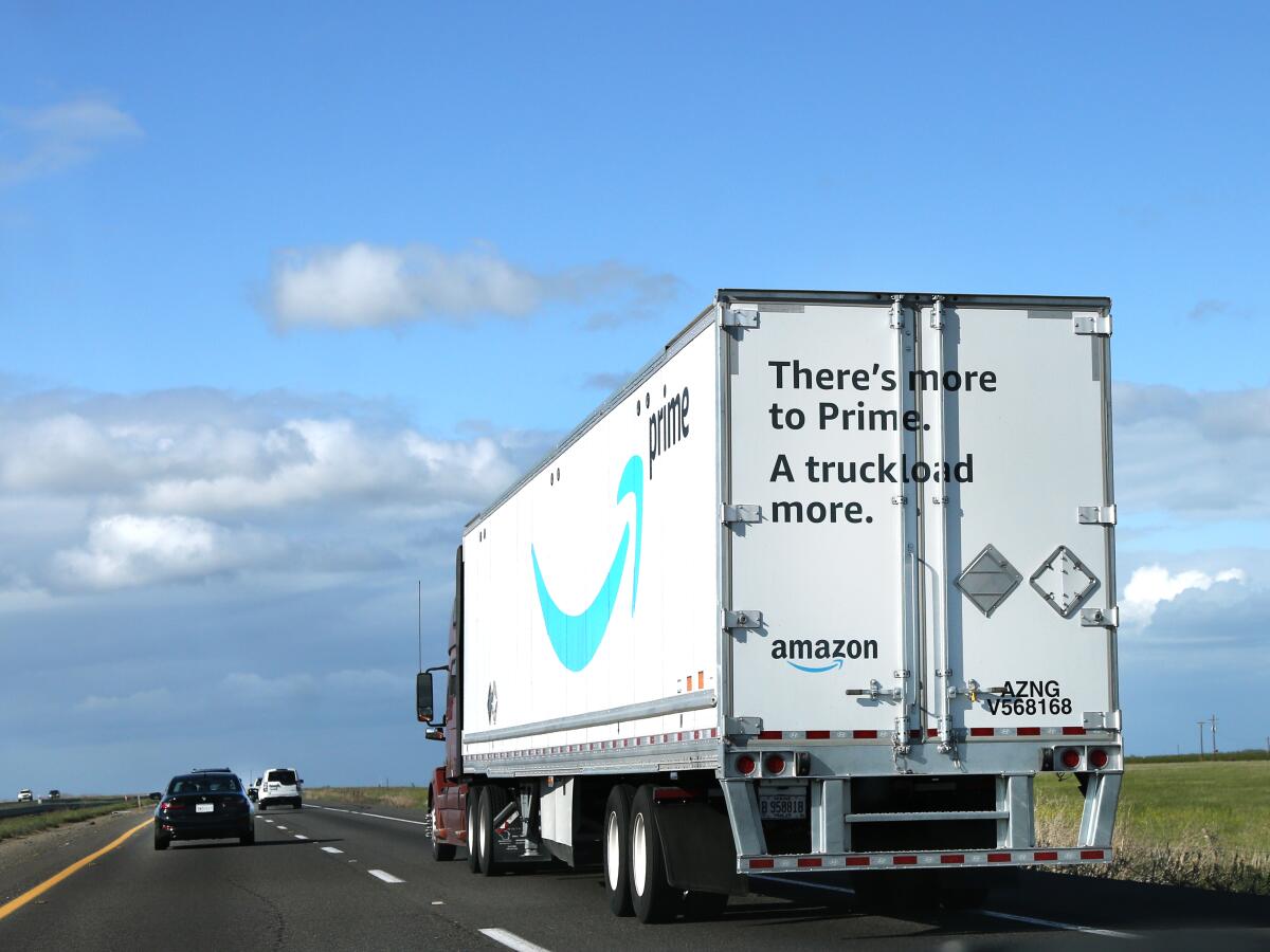 An Amazon delivery truck on a highway. 