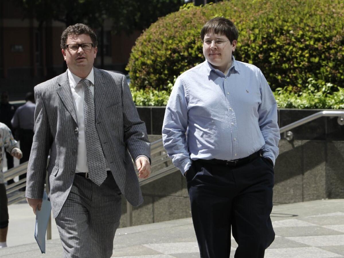 Matthew Keys walks to the federal courthouse for his arraignment with his attorney Jason Leiderman, in Sacramento, Calif., in 2013.