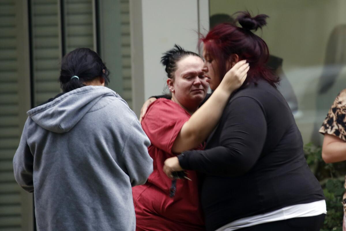 Two women embrace