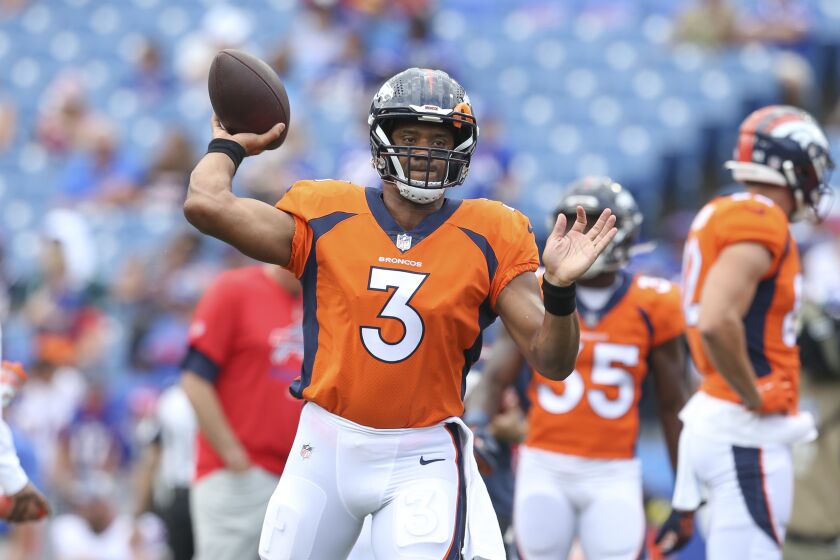 Denver Broncos quarterback Russell Wilson warms-up before a preseason NFL football game against the Buffalo Bills, Saturday, Aug. 20, 2022, in Orchard Park, N.Y. (AP Photo/Joshua Bessex)