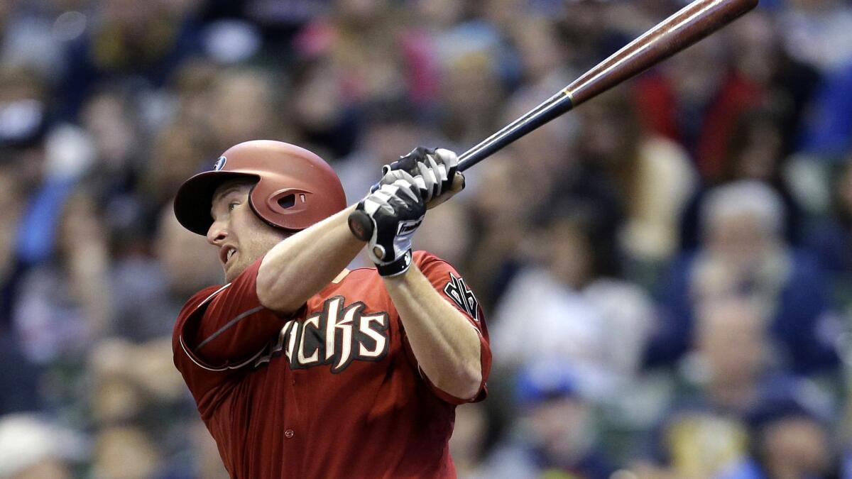 Mark Trumbo follows through on a double during a Diamondbacks game against the Brewers on May 31 in Milwaukee.