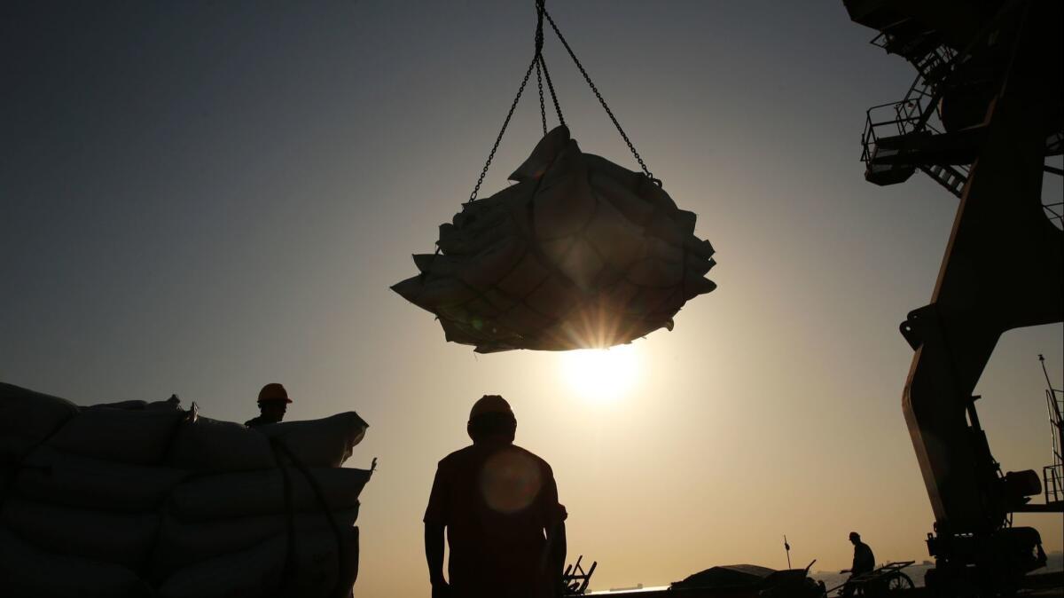 Workers transfer soybeans at a port in eastern China in April. Companies and trade groups in the U.S. and China have expressed concern over an escalating trade spat between the world's two biggest economies.