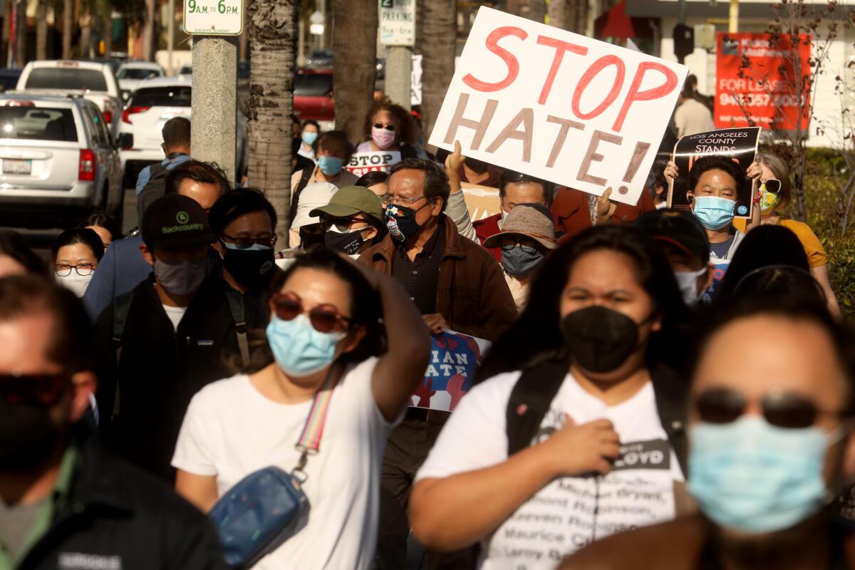 Demonstrators march to denounce anti-Asian sentiment.