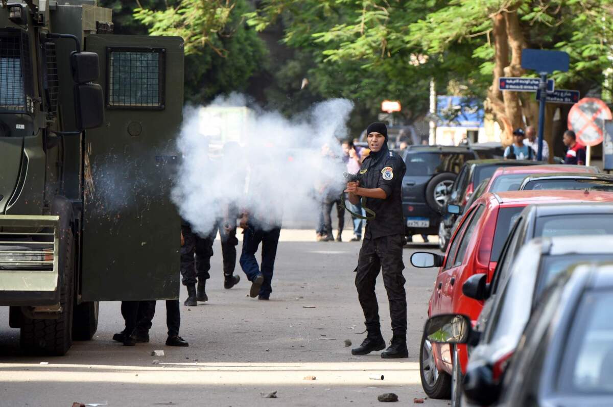Egyptian riot police fire tear gas toward would-be protesters Monday.