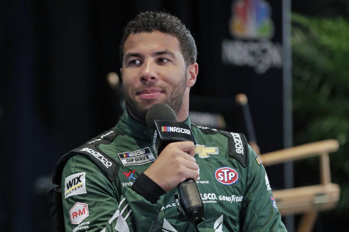 FILE - In this Feb. 12, 2020, file photo, Bubba Wallace takes part in an interview during NASCAR Daytona 500 auto racing media day at Daytona International Speedway in Daytona Beach, Fla. Corporate interest in Bubba Wallace has picked up momentum and NASCAR’s only black full-time driver has signed a new sponsor that includes funding for his Richard Petty Motorports team. Columbia Sportswear signed a multiyear sponsorship with Wallace as a brand ambassador that will also put the company on the No. 43 at Dover later this month. (AP Photo/John Raoux)