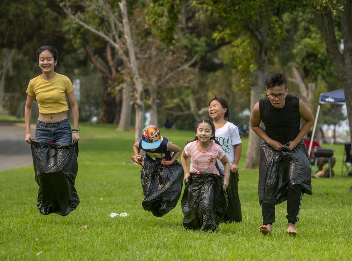 A family celebrates Labor Day with a sack race at Mile Square Park in Fountain Valley.