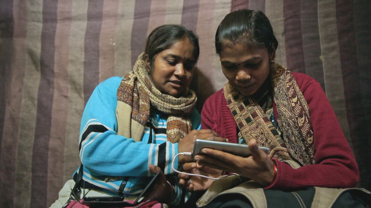 Two women journalists seen in the 2021 documentary “Writing With Fire.”