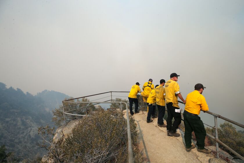 PASADENA, CALIFORNIA - SEPTEMBER 14: Firefighters keep watch from an overlook on Mount Wilson as the Bobcat Fire burns in the Angeles National Forest on September 14, 2020 near Pasadena, California. California's national forests remain closed due to wildfires which have already incinerated a record 2.3 million acres this year. The Bobcat Fire, burning in the San Gabriel Mountains, has grown to over 36,000 acres. (Photo by Mario Tama/Getty Images)