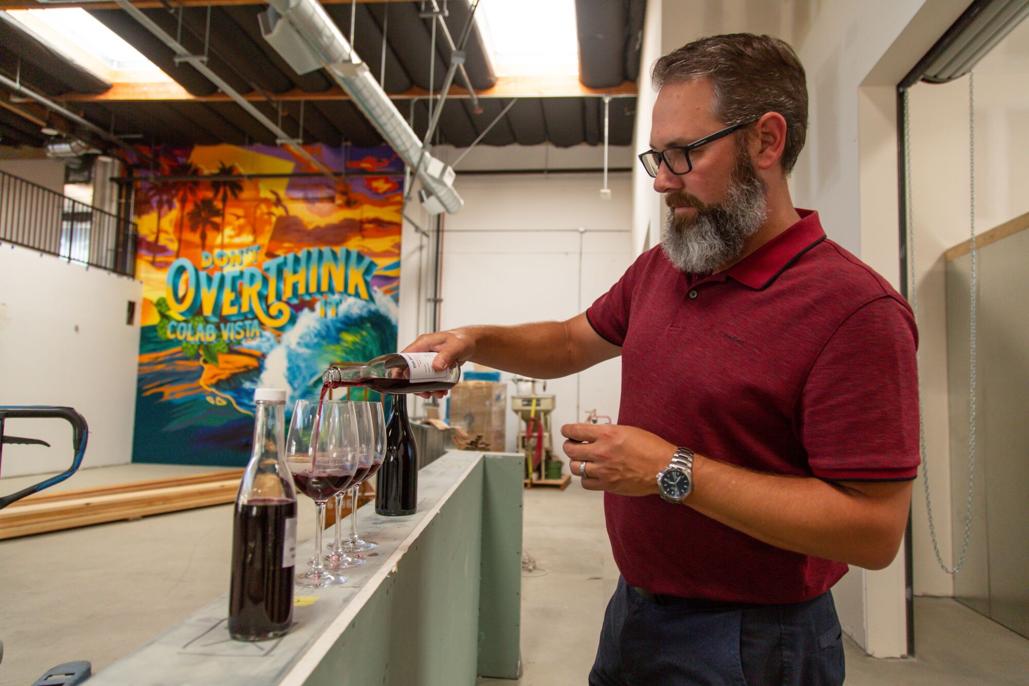 Joseph Deutsch pours samples from the winery that he will be operating inside Co-Lab Vista.