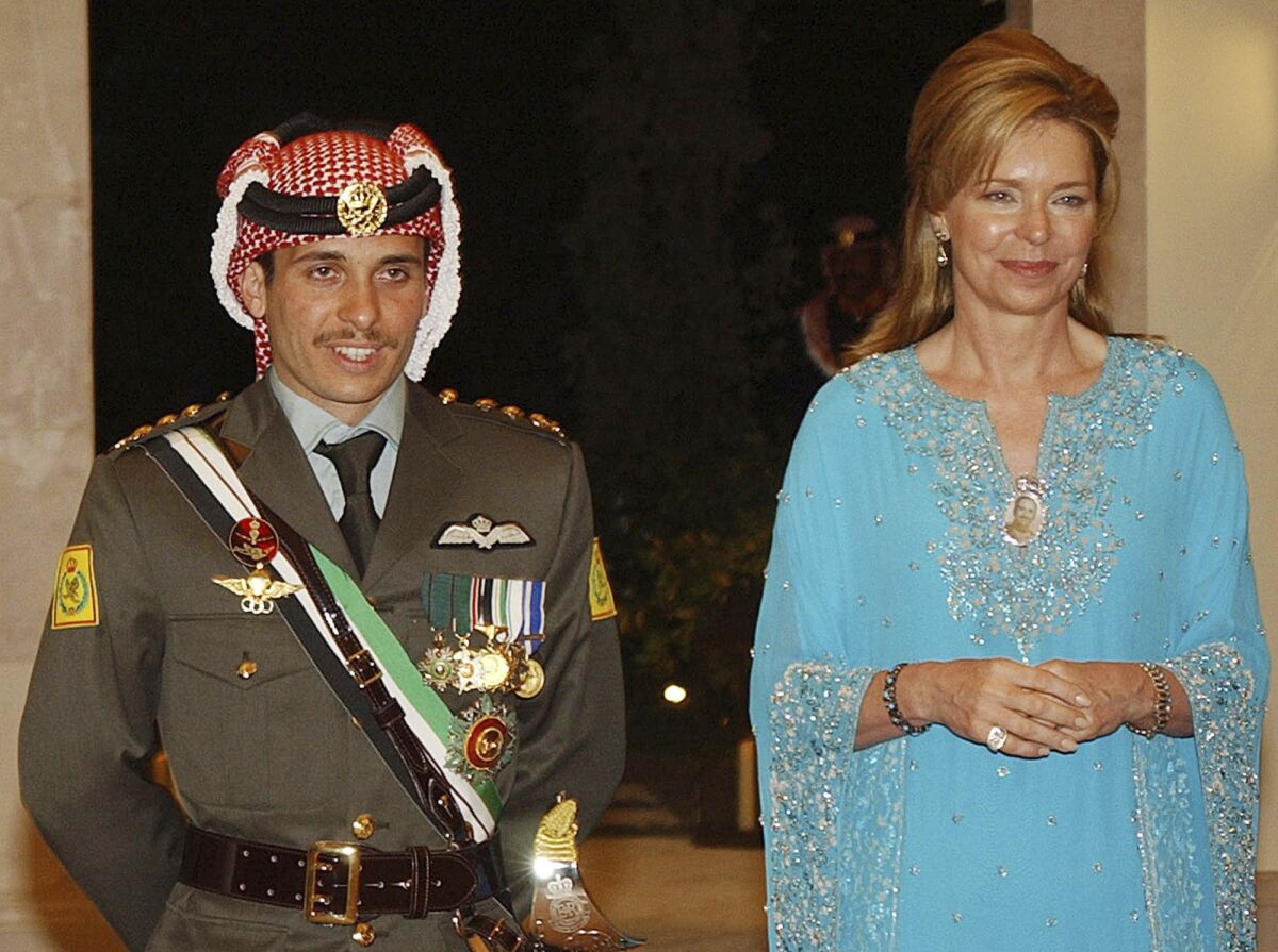 FILE - Then Crown Prince Hamzeh of Jordan, left, with his mother Queen Noor, during his wedding ceremony in Amman, Jordan, May 27, 2004. King Abdullah II of Jordan has gone public with a royal rift with his half-brother Prince Hamzeh and formalized the former crown prince's house arrest, calling him “erratic” in an unprecedented harsh-worded public letter published Thursday, May 19, 2022. The king said in a public letter that he had approved measures to detain Prince Hamzah in his palace and restrict his communications and movements, citing his half brother’s “erratic behavior and aspirations.” (AP Photo/Hussein Malla, File)