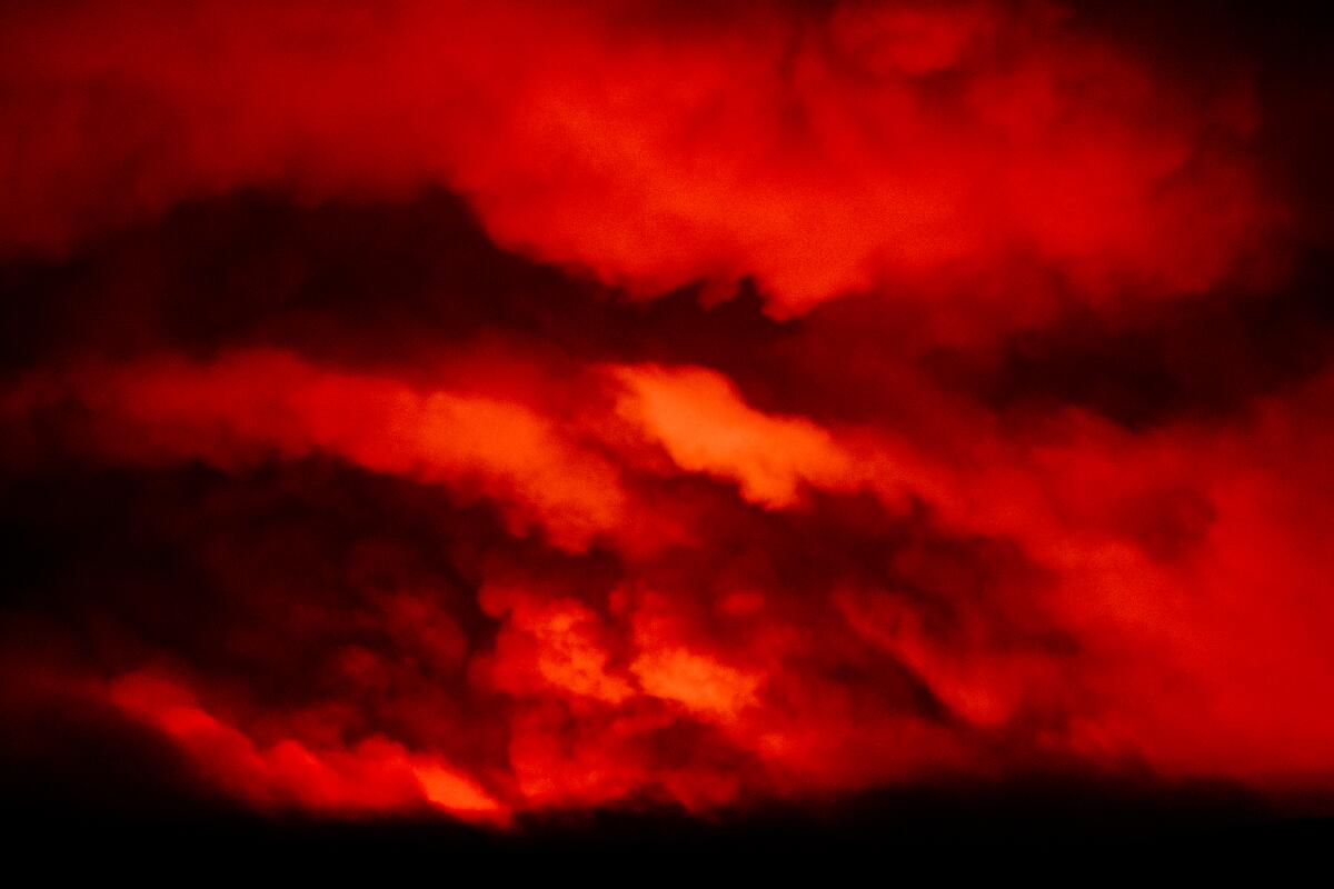 Clouds of smoke glow red 