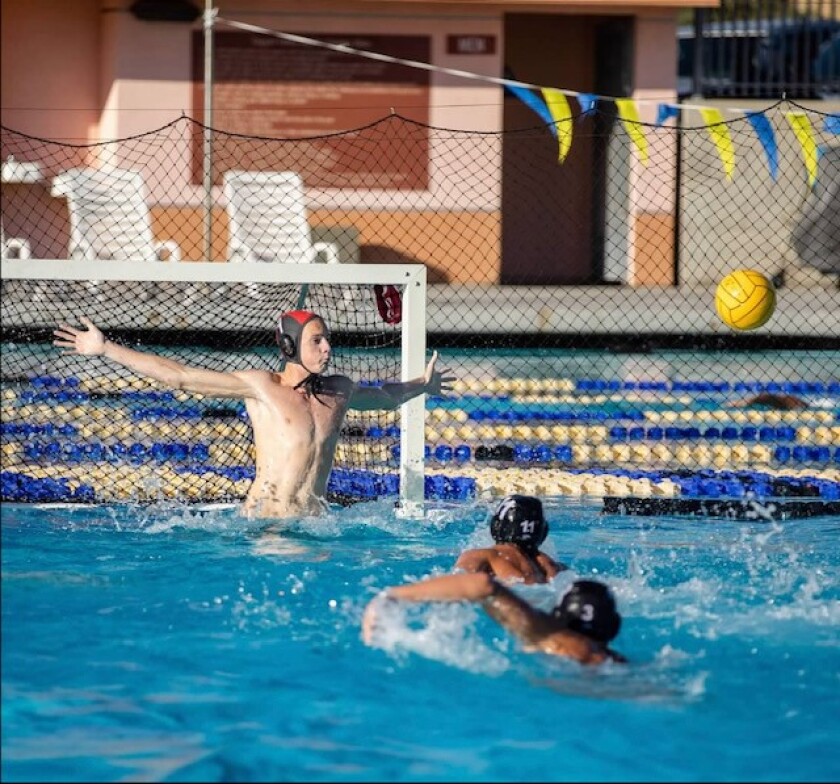 La Jolla High School varsity water polo goalie Max LaGrange blocks the net.