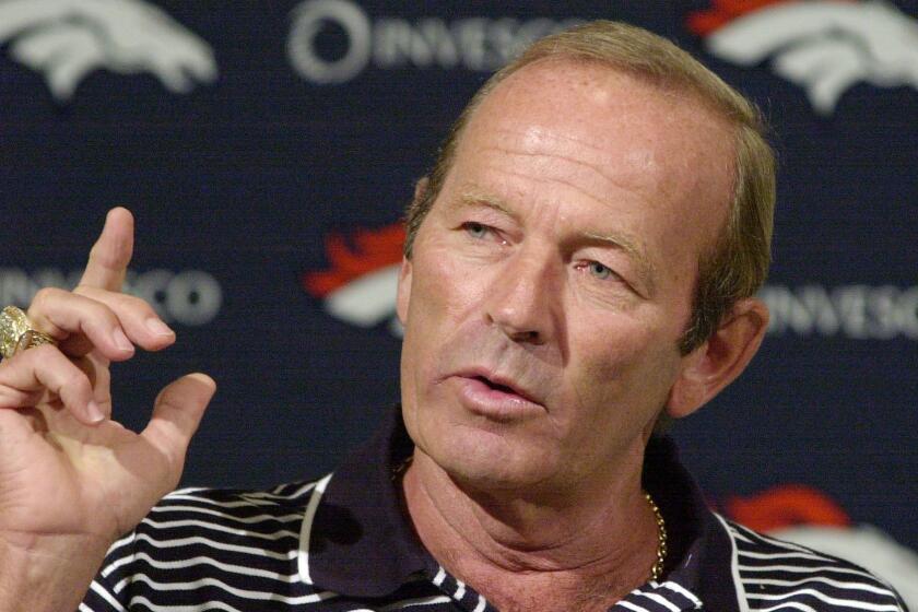 FILE - In this Aug. 20, 2002, file photo, Denver Broncos owner Pat Bowlen gestures during a news conference at the team's headquarters in Denver. Pat Bowlen, the Denver Broncos owner who transformed the team from also-rans into NFL champions and helped the league usher in billion-dollar television deals, died late Thursday night, June 13, 2019, just under two months before his enshrinement in the Pro Football Hall of Fame. He was 75. In a statement posted on the Broncos' website, Bowlen's family said he died peacefully at home surrounded by loved ones. (AP Photo/Ed Andrieski, File)