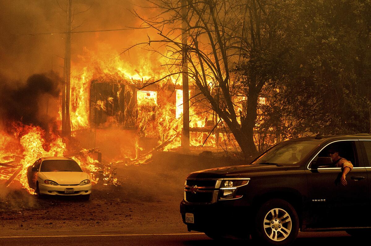 Flames from the Dixie fire consume a home on Highway 89 south of Greenville Calif., on Aug. 5, 2021.
