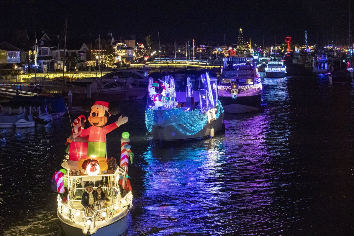 Nearly 100 boats participate in the opening day of the Newport Beach Christmas Boat Parade.
