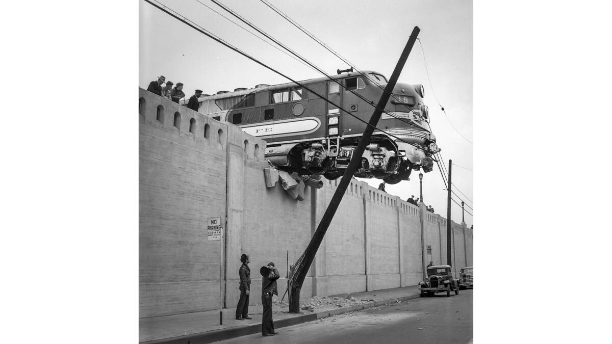 A locomotive hangs over a street