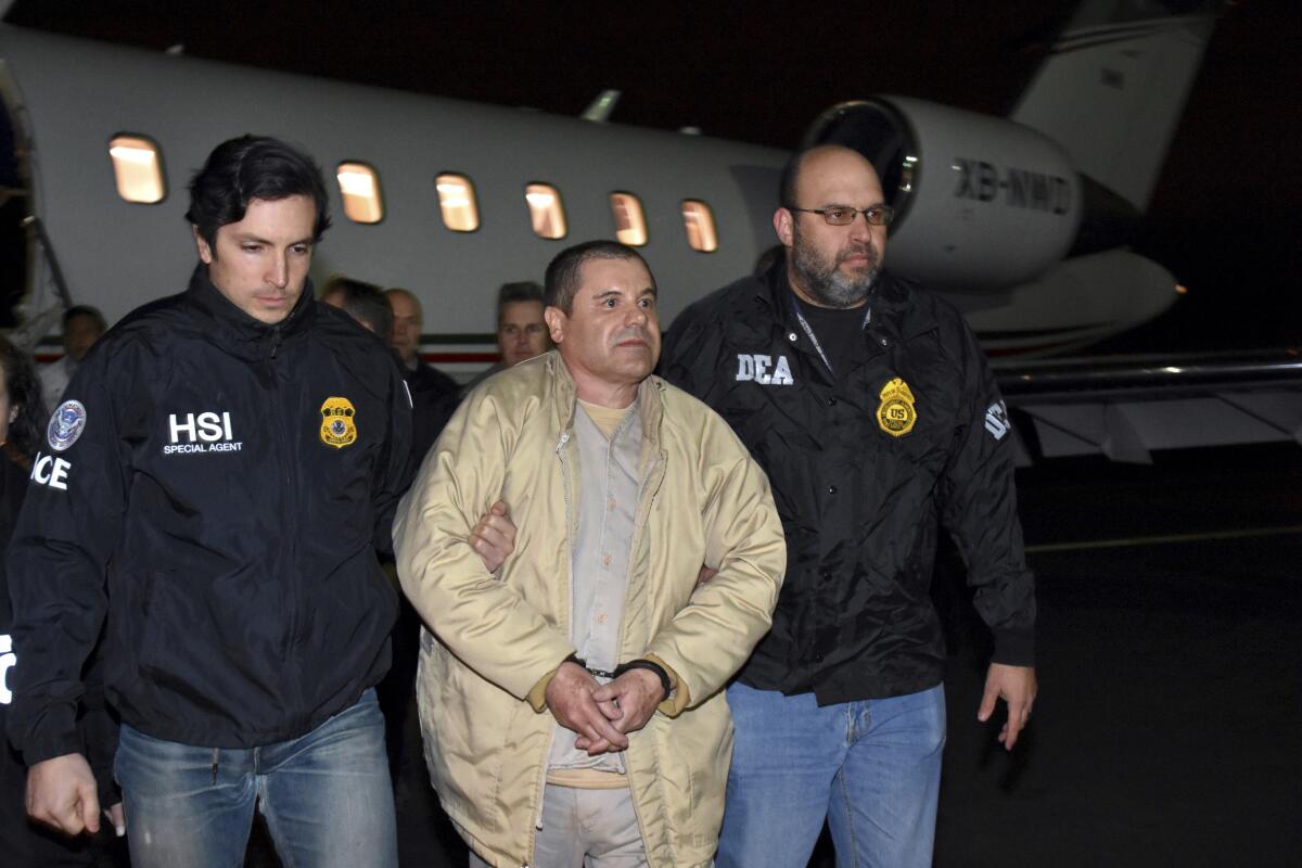 A man in handcuffs escorted by police