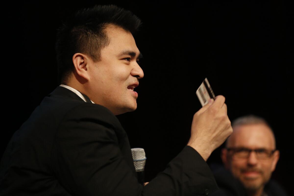 Jose Antonio Vargas holds up his California driver's license while speaking on the Human Rights and Social Justice panels during the 20th Los Angeles Times Festival of Books at USC on Saturday, April 18, 2015.